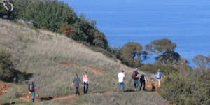 a group of people walking up a hill