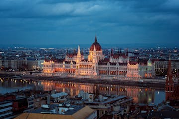 a view of Hungarian Parliament Building next to a body of water