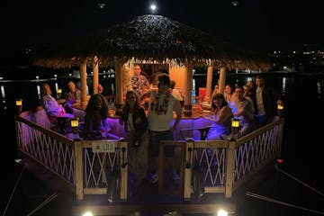 a group on board a cancun palapa tours' floating tiki bar in cancun, mexico