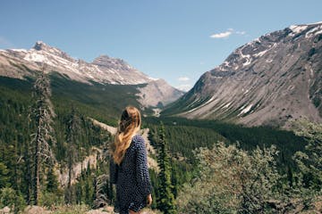a person standing in front of a mountain