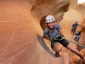 two people rappelling down a slot canyon