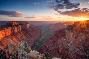 a canyon with a sunset in the background