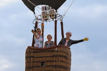 people waving to the camera on board pagosa adventure's hot air balloon in pagosa springs, colorado