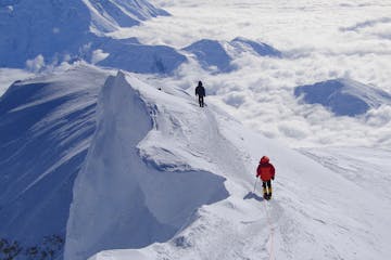 two men climbing up the Denali Mountain