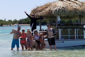 a group of people standing next to a tiki boat