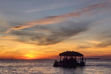 tiki boat adventures at sunset