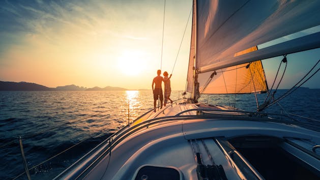 couple on sailboat at sunset