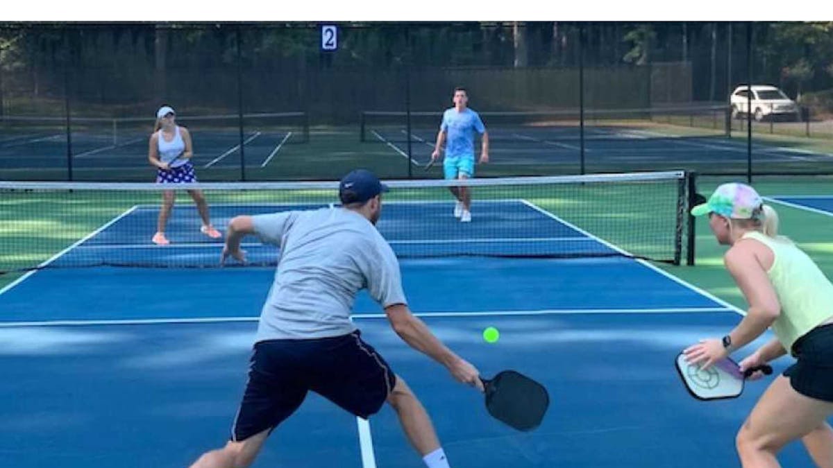 a person hitting a ball with a racket on a court