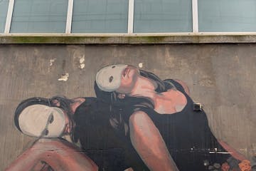 a man lying on the side of a building