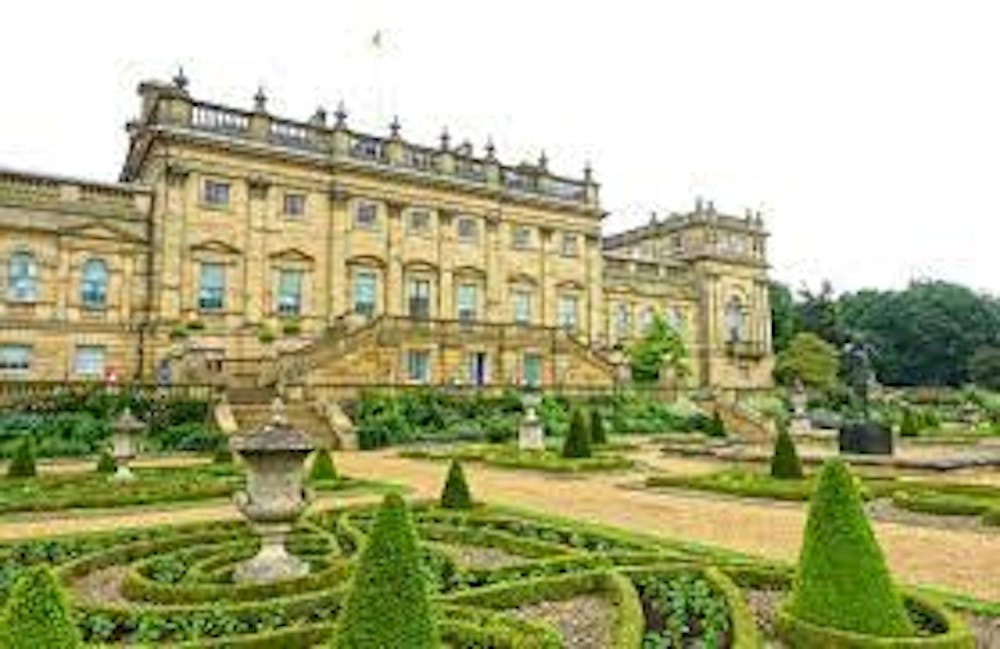 a large building with Harewood House in the background
