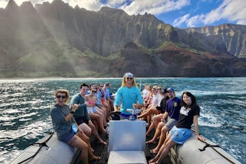 Boat tour passengers having a good time in front of The Kalalau Cathedral Cliff