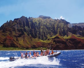 Passengers on a Na Pali Coast Boat Tour in front of Kalalau in Kauai