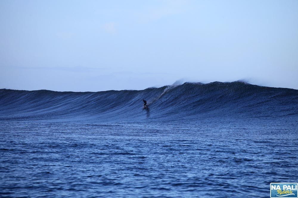 a man riding a wave on top of a body of water