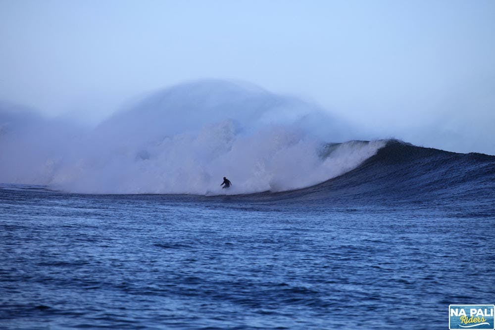 a man riding a wave on top of a mountain