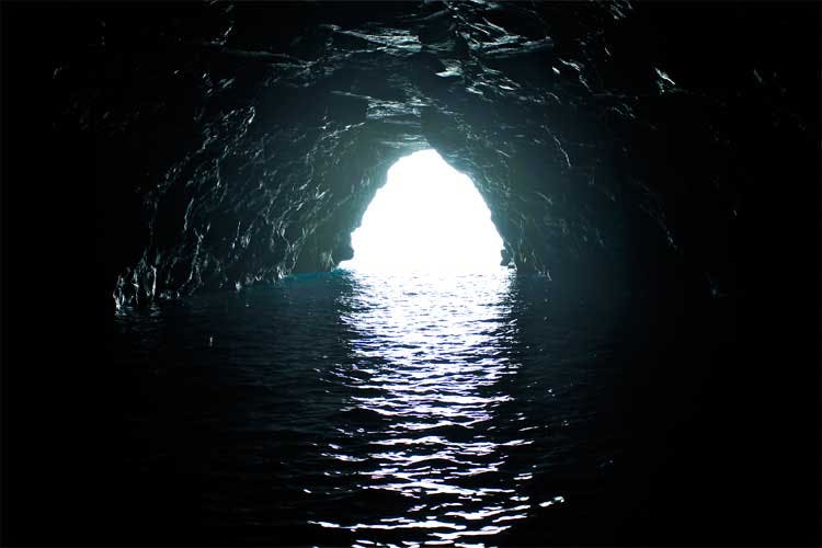 a tunnel with water in the dark