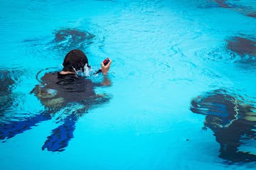 a person swimming in a pool of water