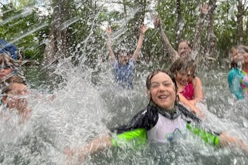 a group of people playing in the water