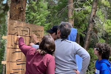 a family looking at a map on a private treasure hunt tour with country boy mine in breckenridge, colorado
