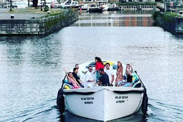a group of people in a boat on a body of water