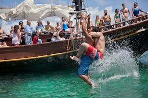 a group of people riding on the back of a boat