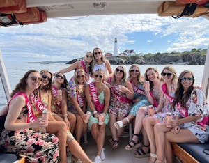 Bachelorette Party posing in front of Portland Headlight on a private boat charter.