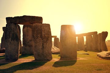 a group of memorial with Stonehenge in the background