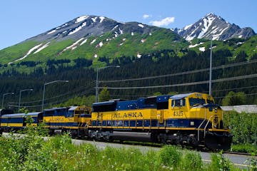 a train is parked on the side of a mountain