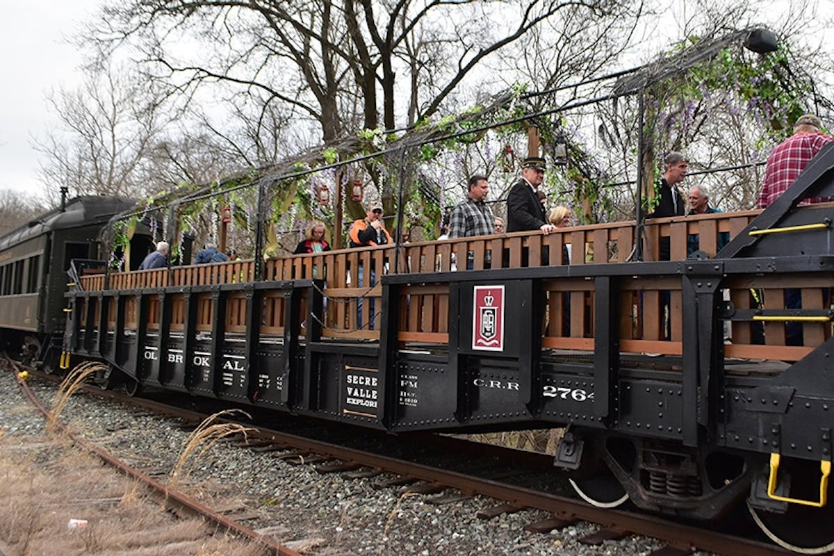 a group of people on a train track with trees in the background