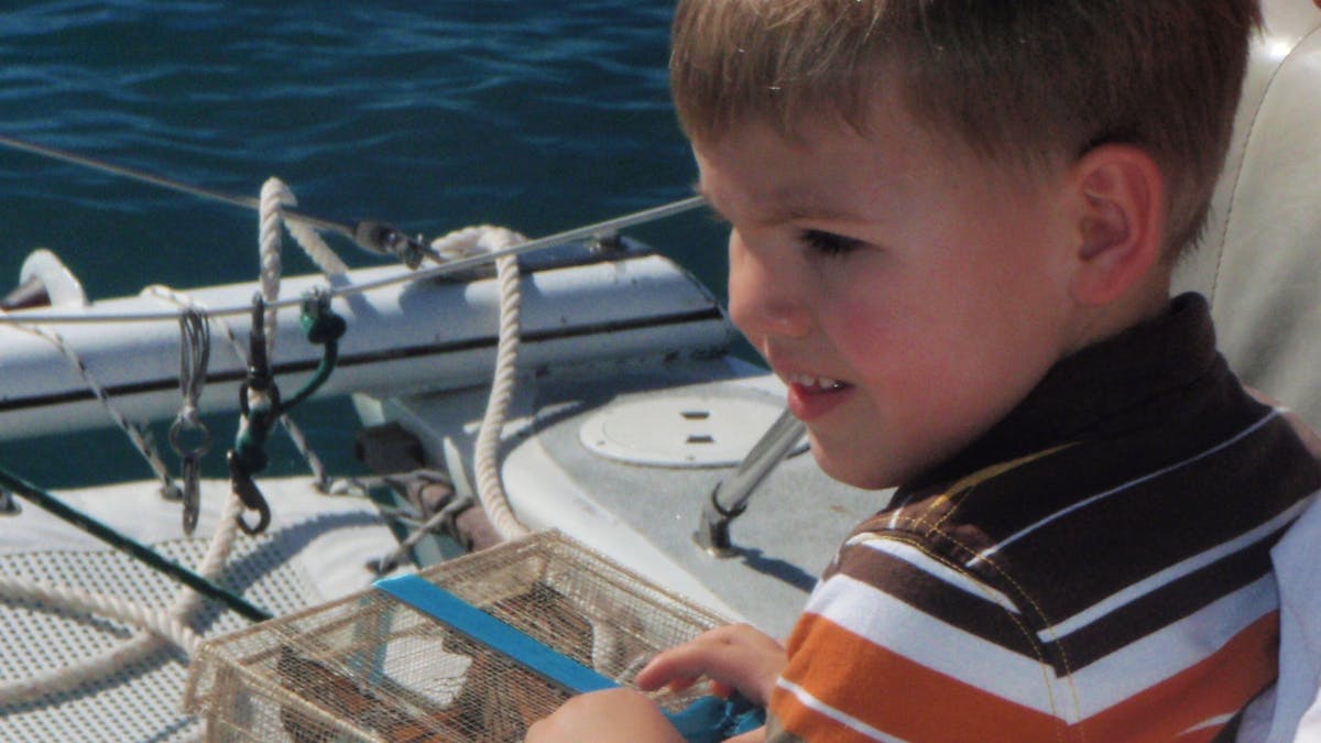 a little boy sitting on a boat