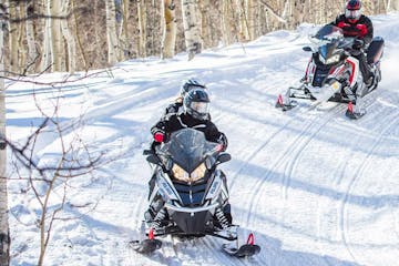 group of people riding snowmobiles at snowmobile vermont bridgewater
