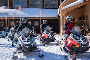 a snowmobile tour group waits to ride on the best snowmobile tour in the east, snowmobile vermont.