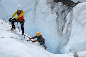 people ice climbing on glacier