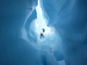 humans climbing in blue ice