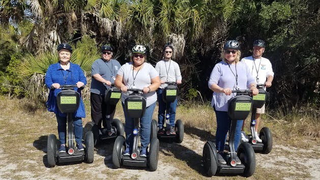 6 Segway Riders with brush behind
