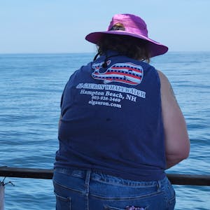 a person standing next to a body of water