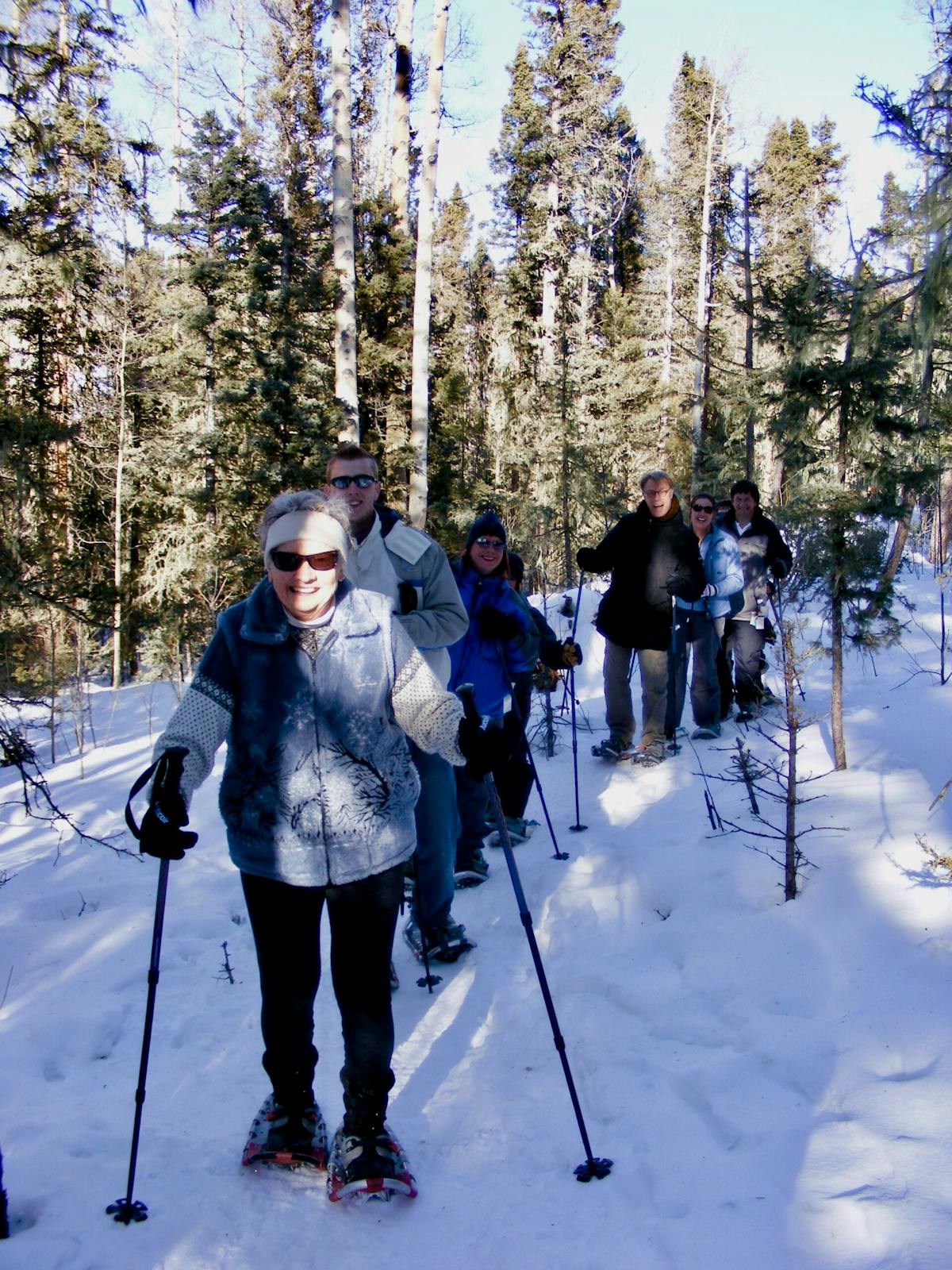 a group of people cross country skiing in the snow